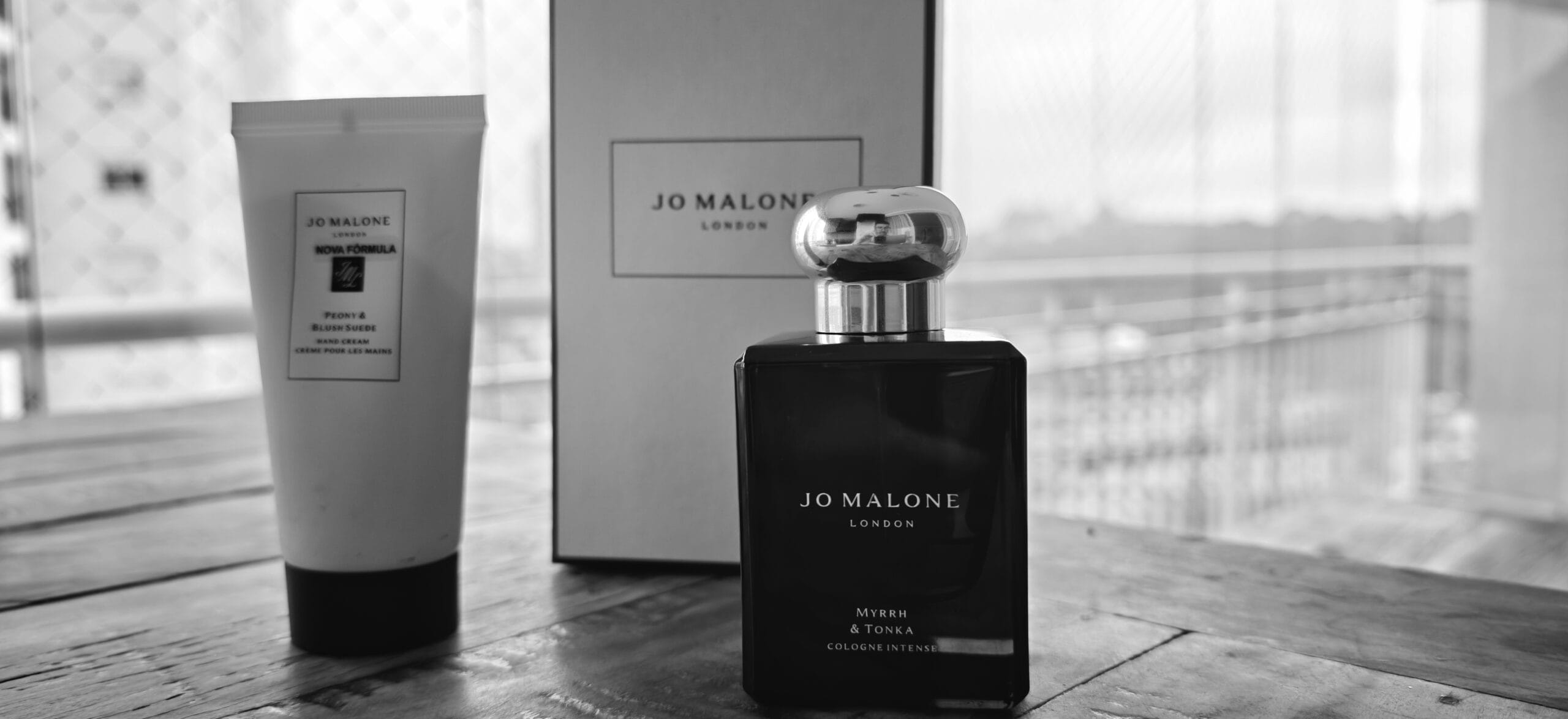 Jo Malone London Myrrh & Tonka Cologne Intense bottle on a wooden surface with the original box — SS Tested review by Felipe's wife