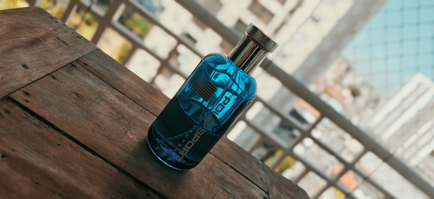 Ralph Lauren Polo Sport blue bottle on wooden surface — aquatic aromatic fragrance detail